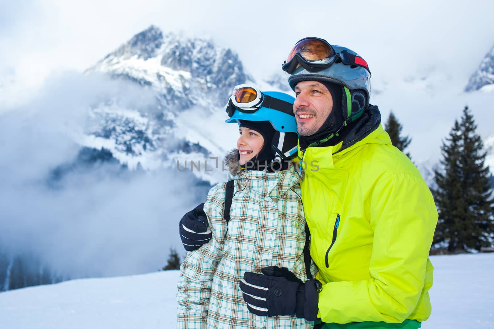Ski, winter, snow, skiers, sun and fun - Family - father and daughter enjoying winter vacations.