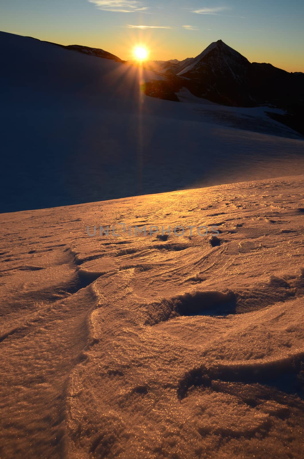 Sunrise in high mountains above the glacier