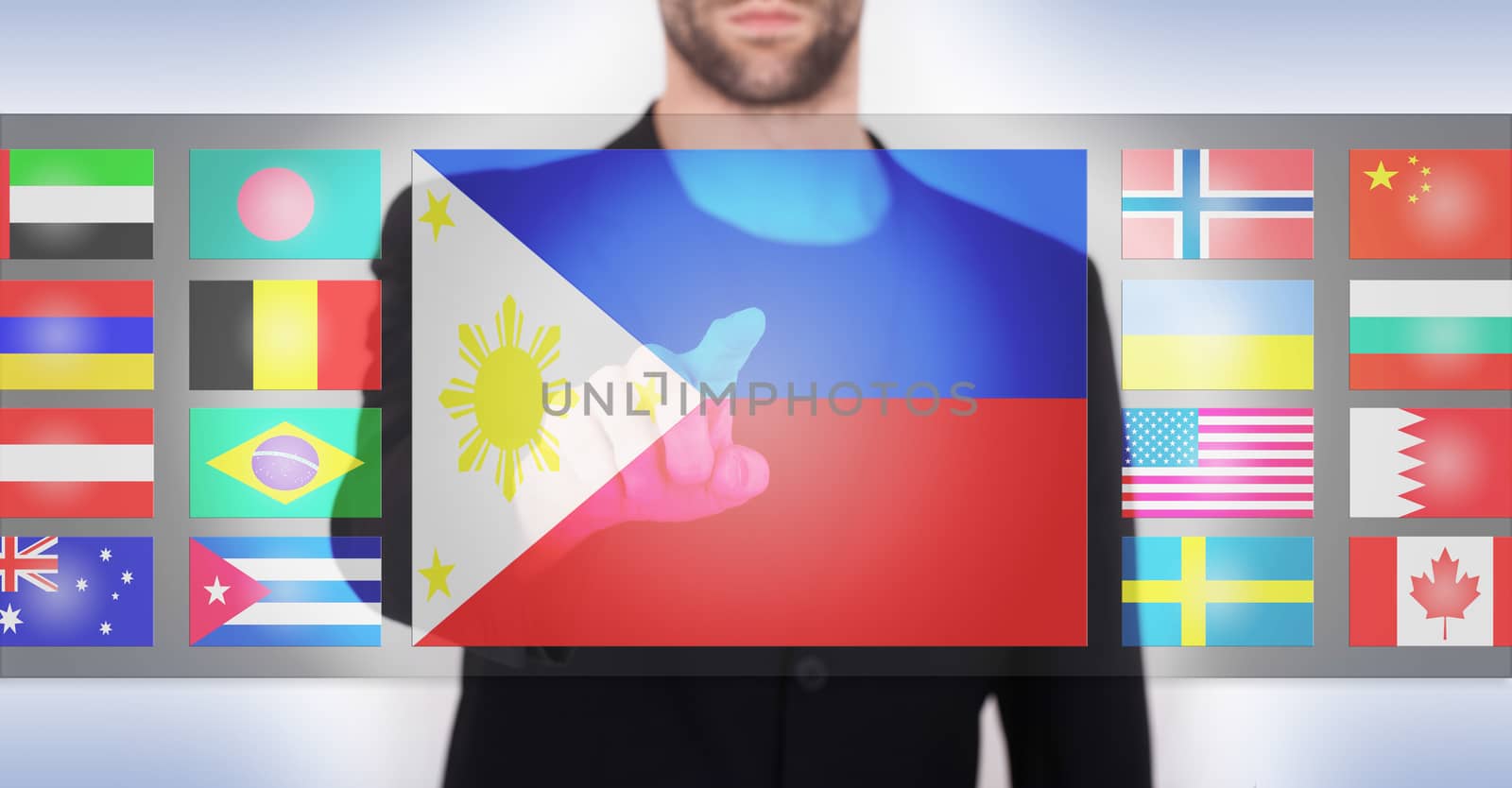 Hand pushing on a touch screen interface, choosing language or country, the Philippines