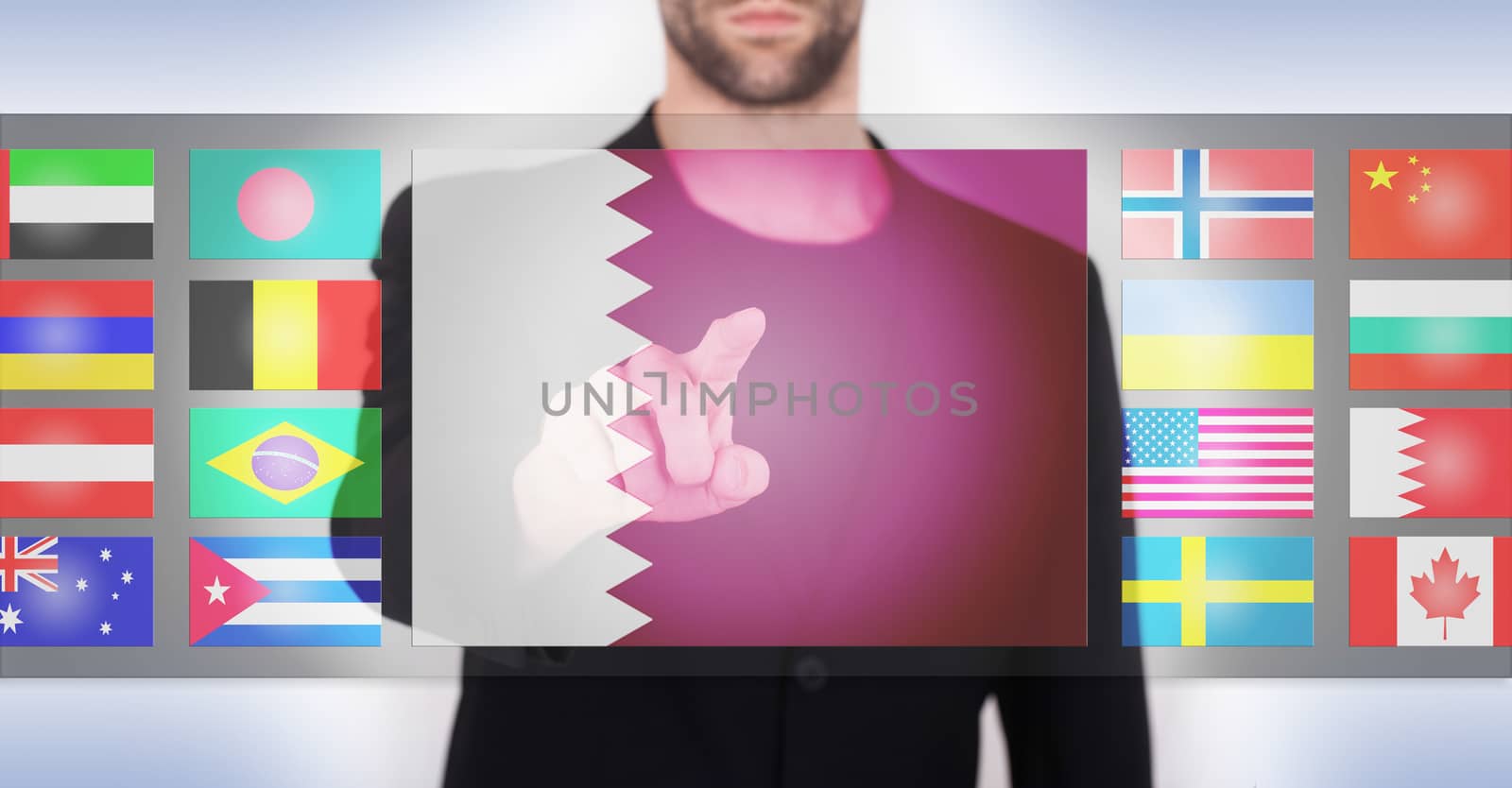 Hand pushing on a touch screen interface, choosing language or country, Qatar