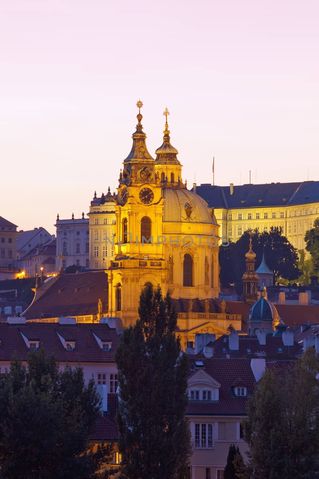 czech republic, prague - illuminated st. nicolaus church at dusk