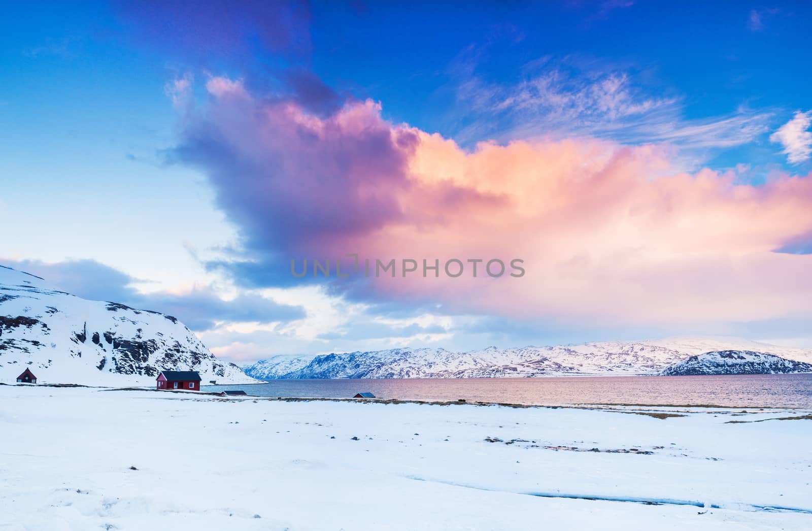 Winter in Norway - Sunset in mountains with red house and the ocean. Panorama