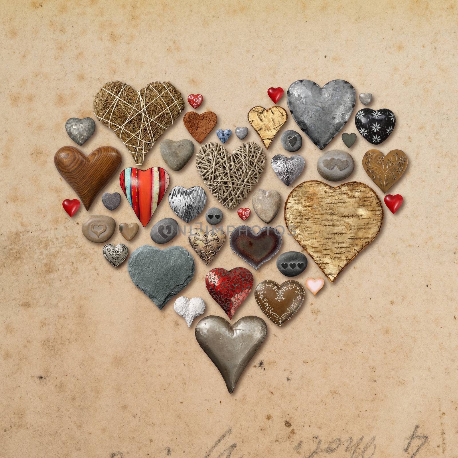 Photo of heart-shaped things made of stone, metal and wood organized in the shape of a heart over vintage paper background.