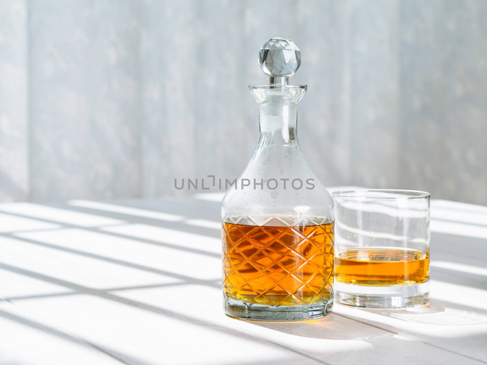 Whisky decanter and rocks glass by the window by sumners