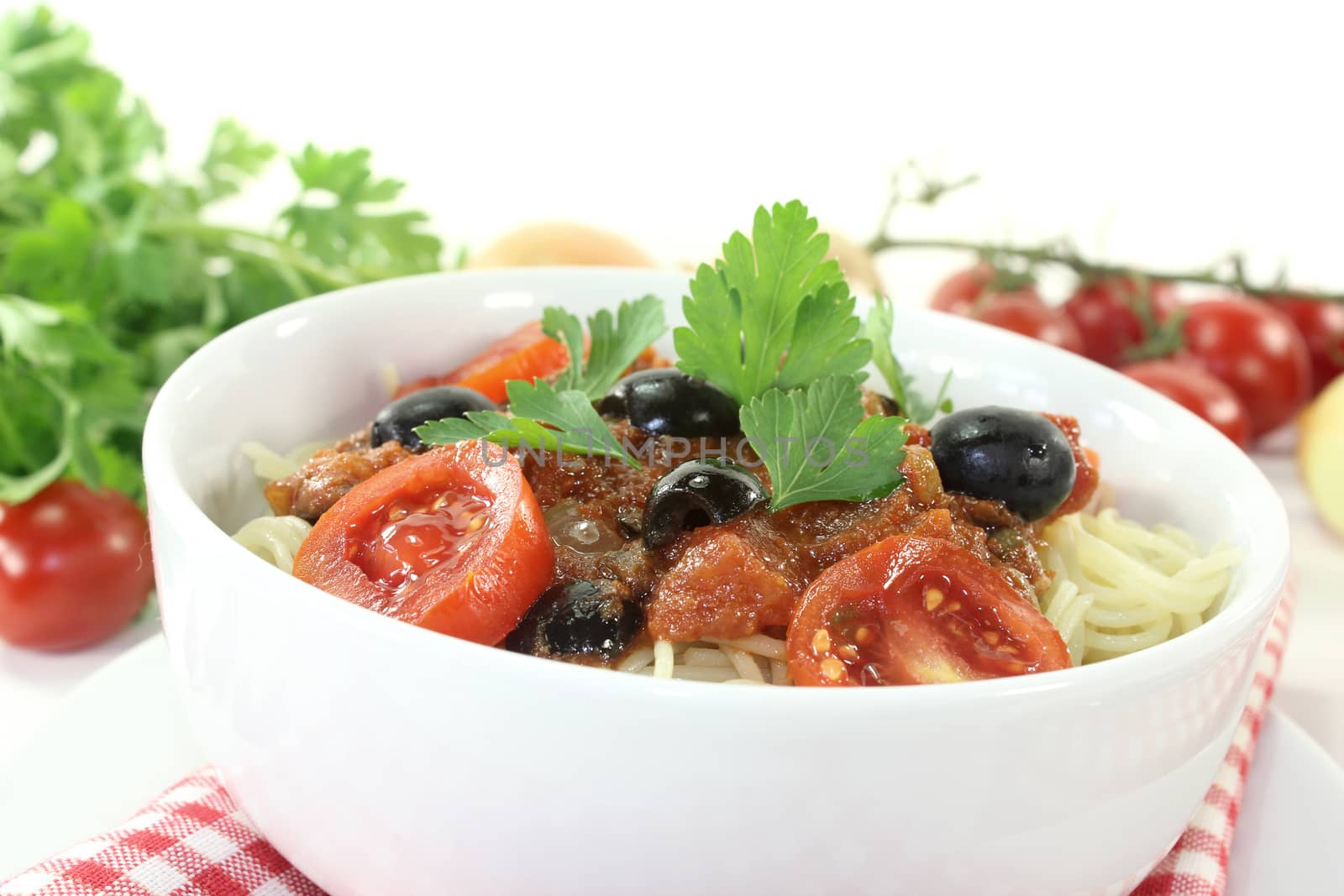 Spaghetti alla puttanesca on light background