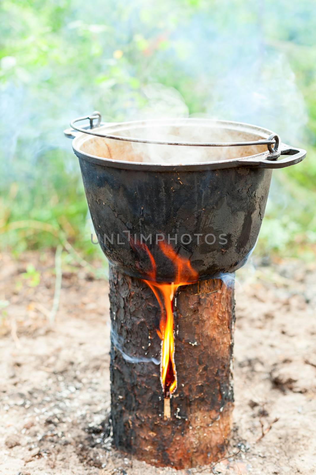 Cooking Goulash soup in cauldron on Finnish (Swedish) log stove