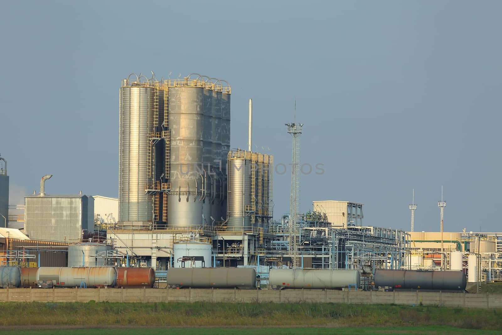 Oil refinery buildings with big silos