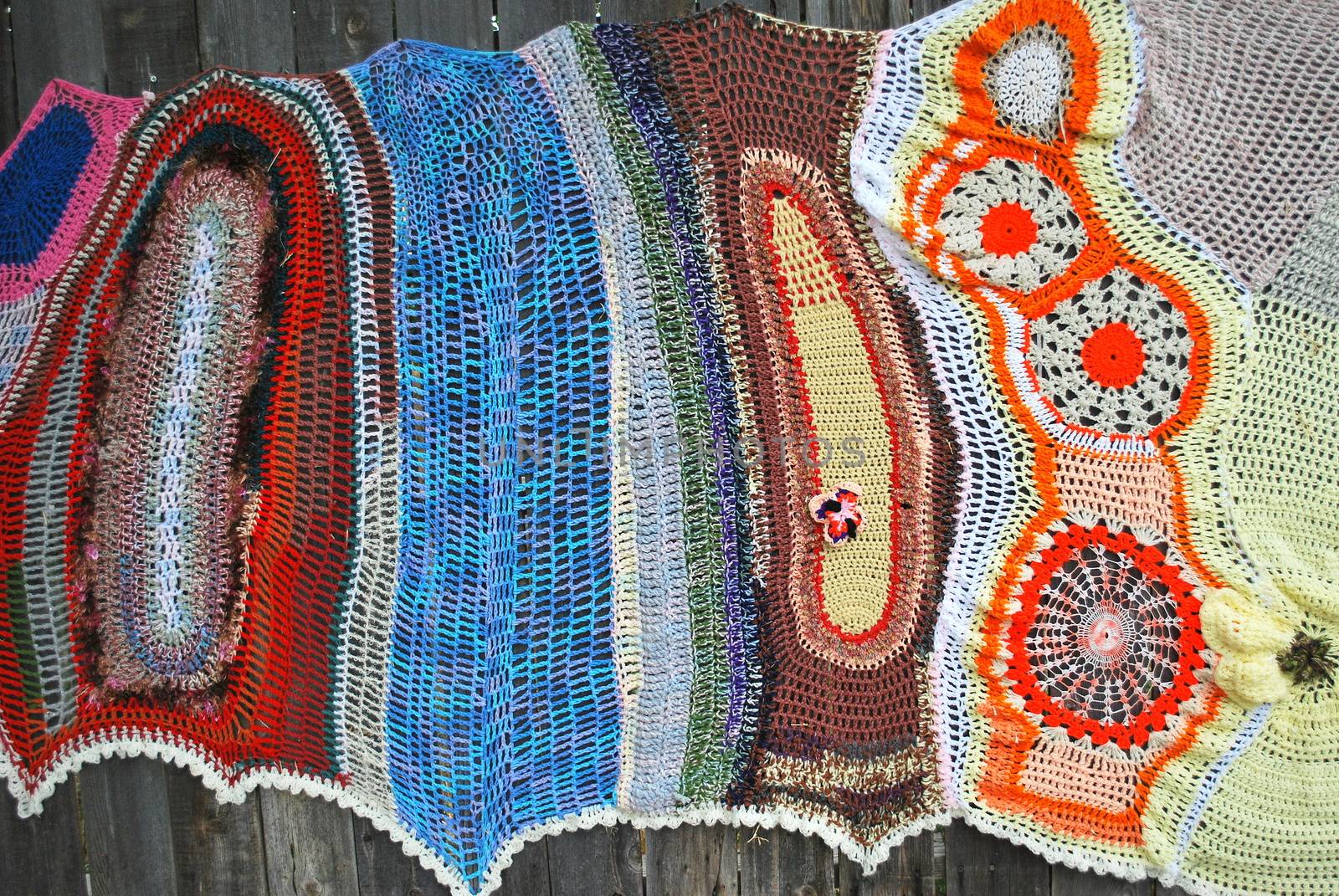 Colorful crochet patterns displayed outside.