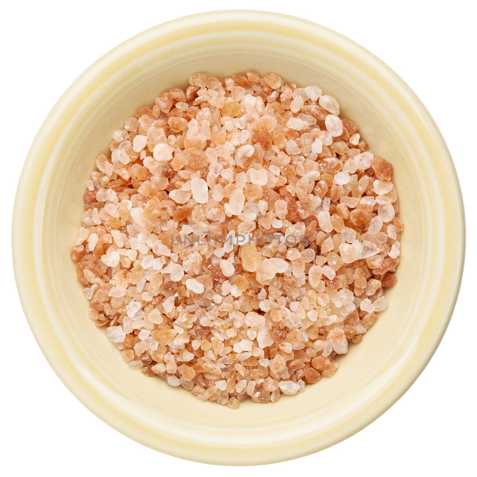 Himalayan salt coarse crystals in a ceramic bowl isolated on white