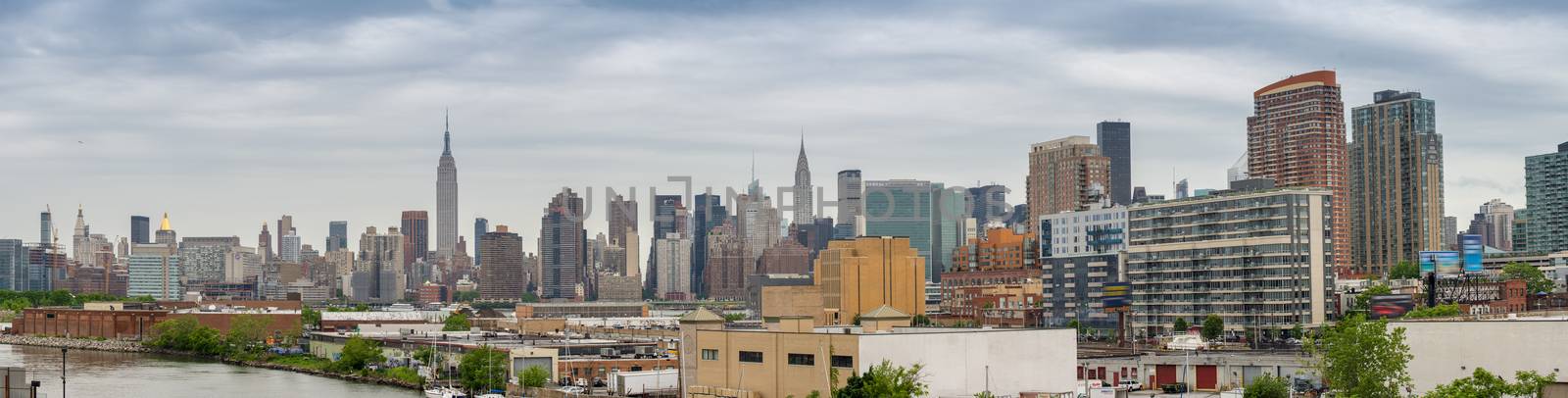 Midtown Manhattan eastern side panorama. Wonderful hi-res view from Brooklyn on a cloudy day.