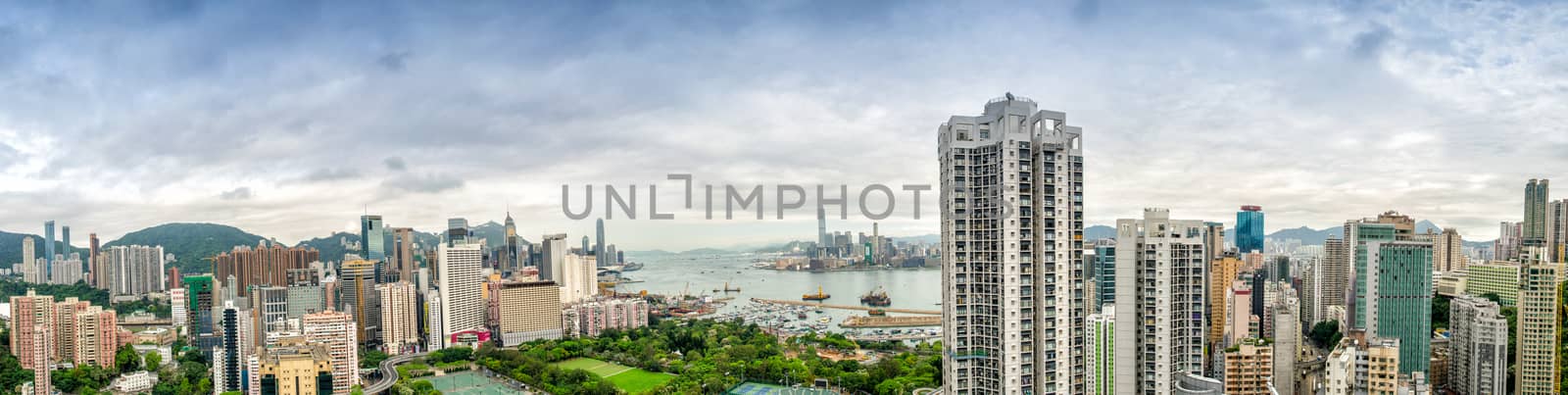 HONG KONG - MAY 12, 2014: Stunning panoramic view of Hong Kong Island and Kowloon on a cloudy day. Last year HK hosted more than 54 million visitors, most of them from the mainland.