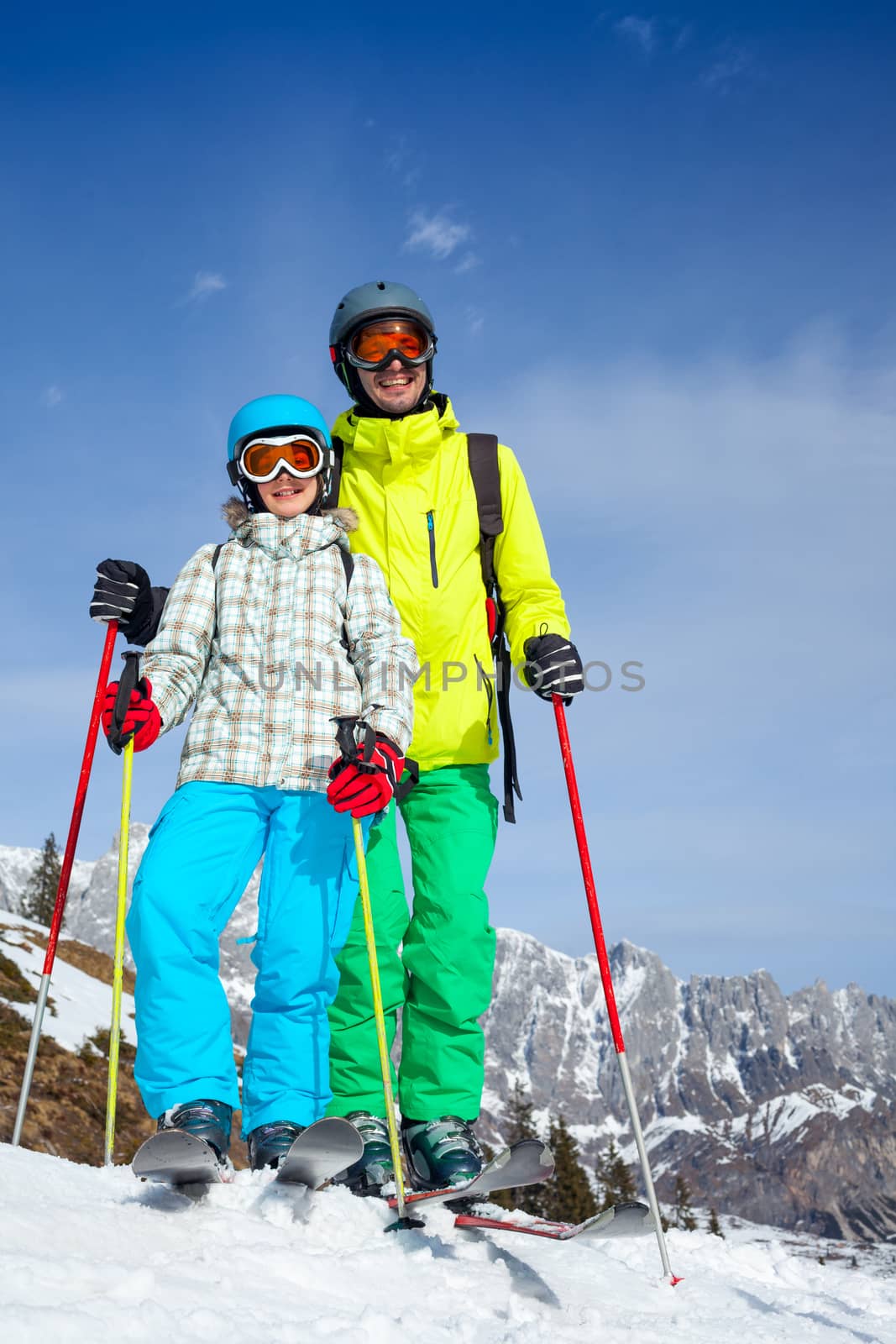 Ski, winter, snow, skiers, sun and fun - Family - father and daughter enjoying winter vacations.
