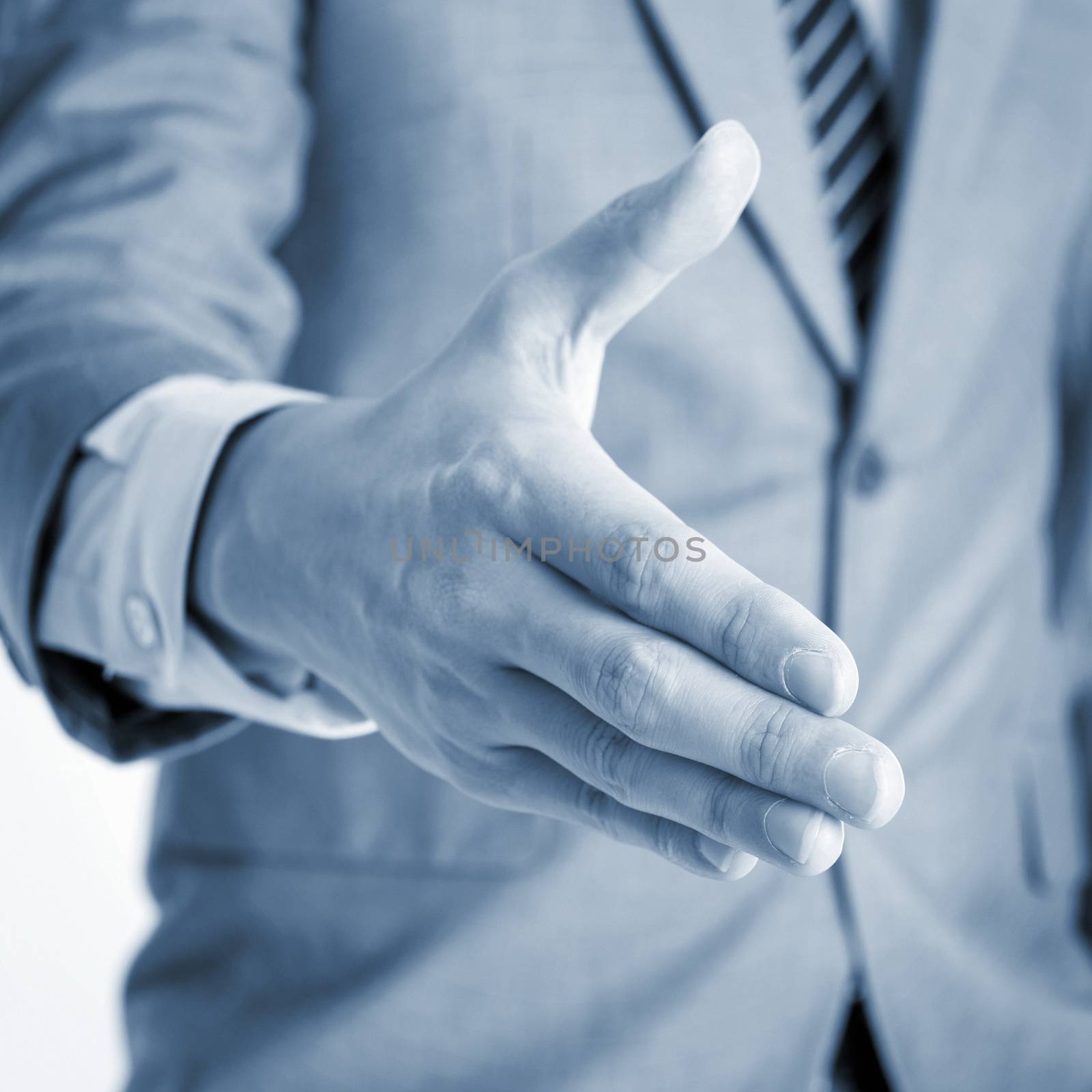 Close up businessman offer hand shake, in blue toned effect.