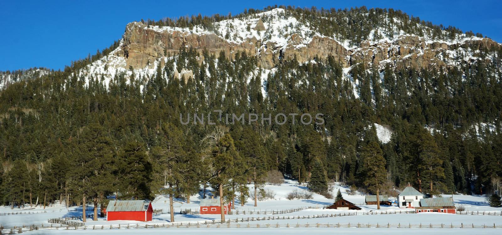 Red house under the snow mountain in the winter