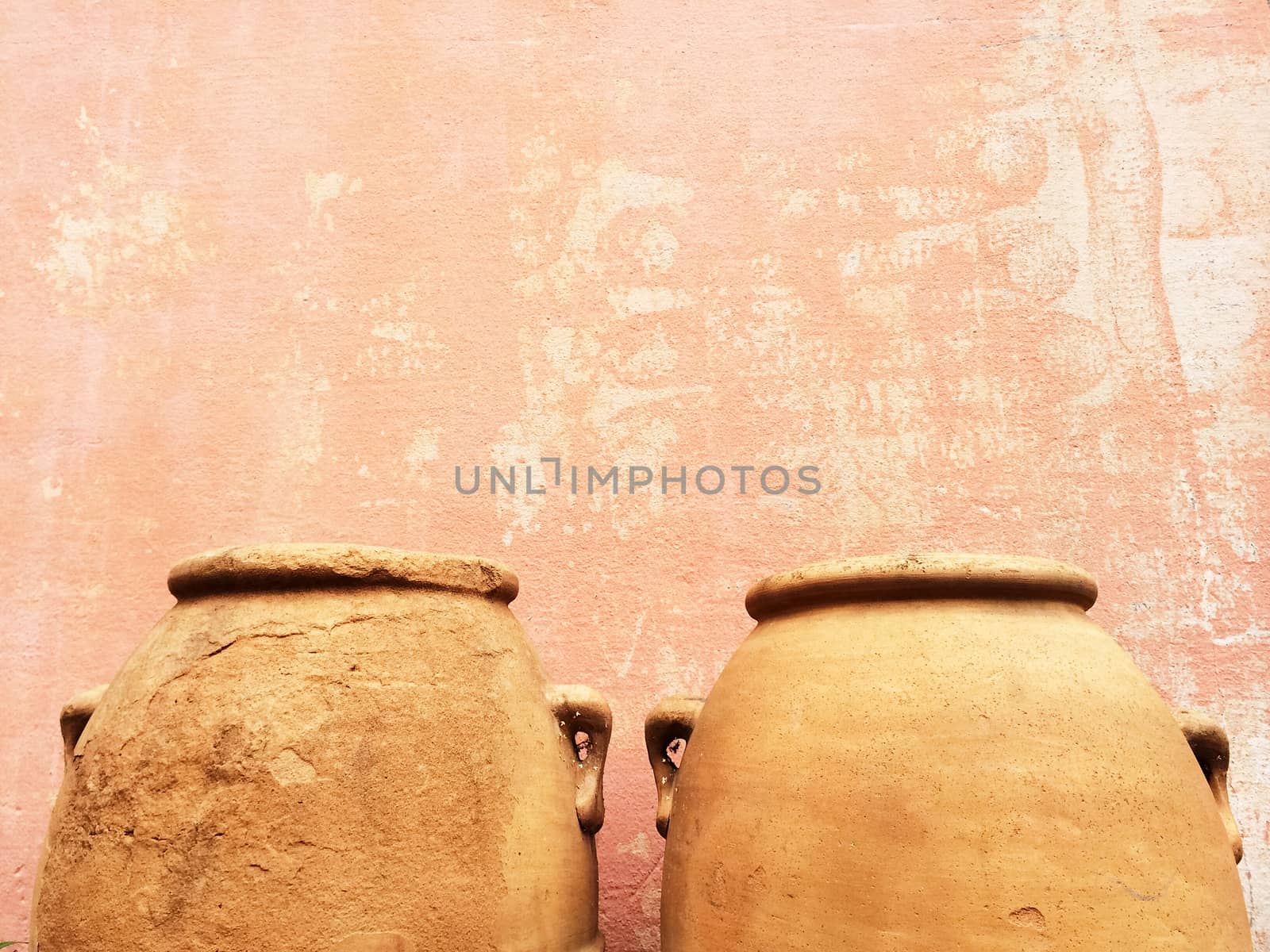 Clay amphoras near an old wall, traditional craft.