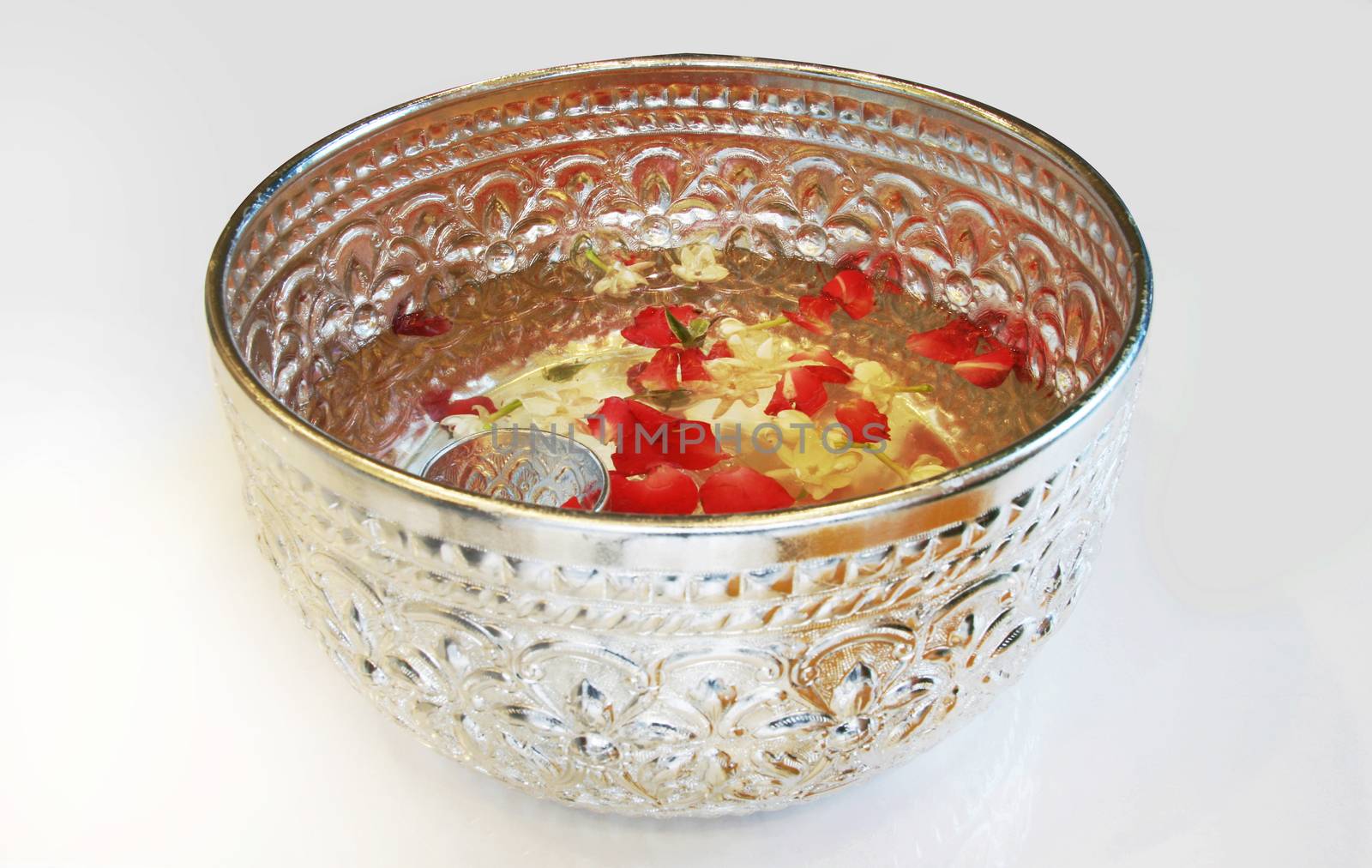 Water with rose petal and jasmine in silver bowl in Thai style by yanukit