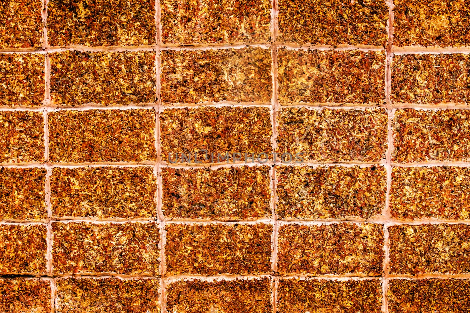 close up Laterite stone brick wall by yanukit