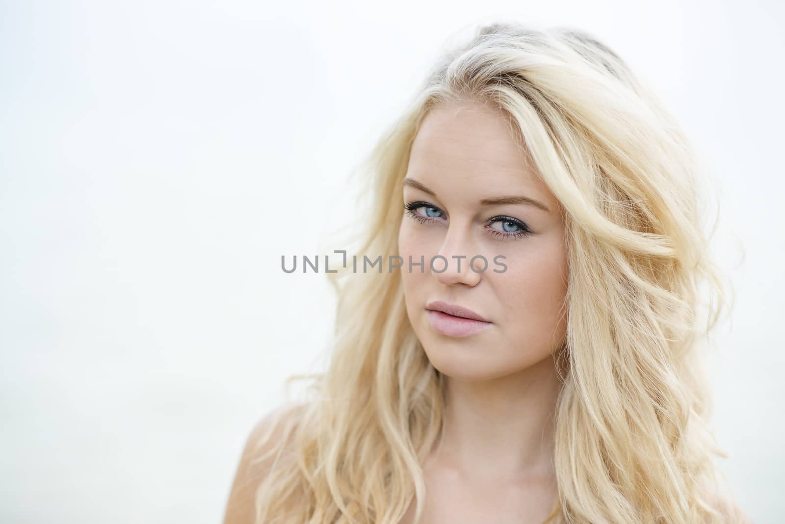 Bright portrait of a young blond woman in summer
