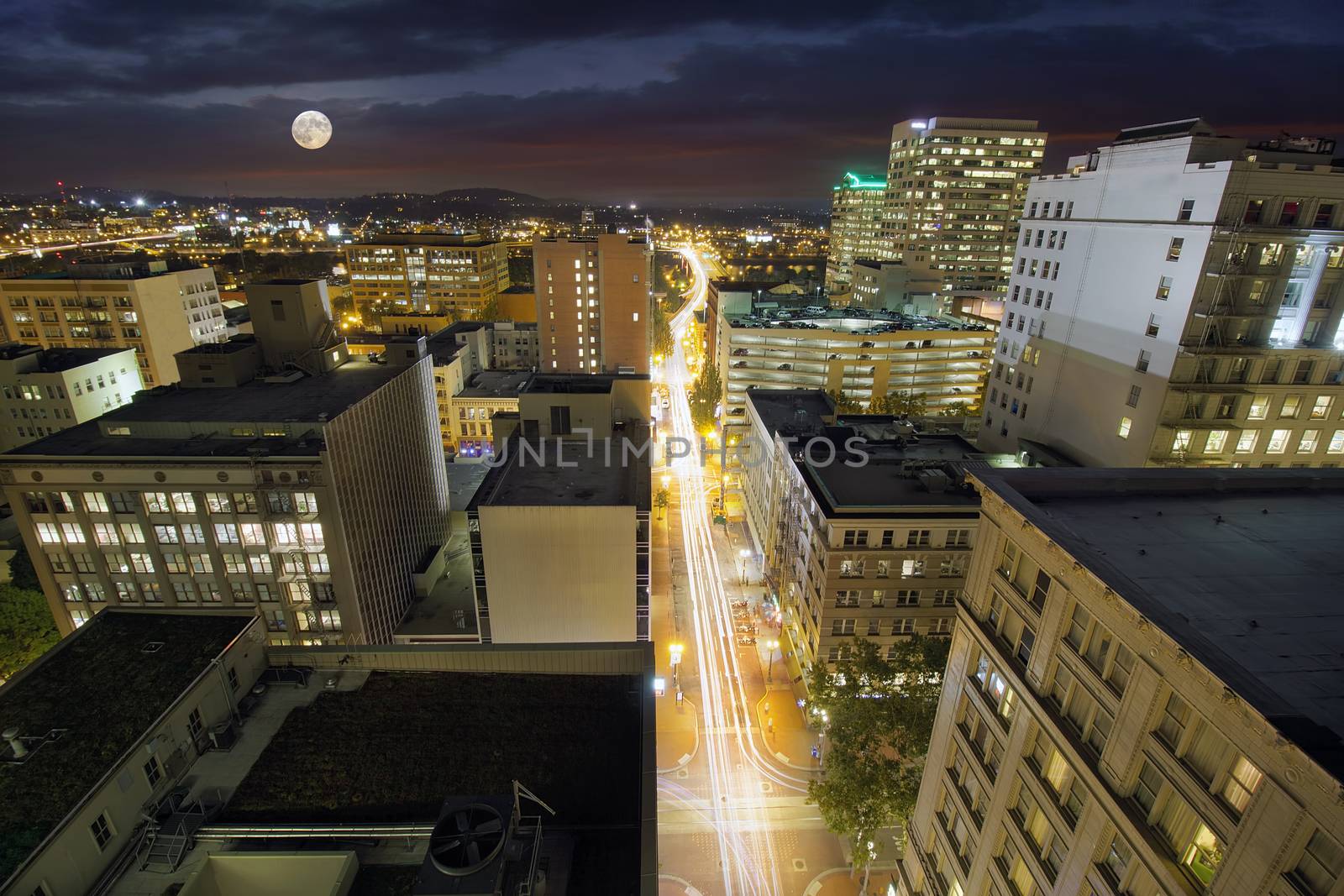 Full Moon Rising Over Portland Oregon Cityscape with Long Exposure Traffic Light Trails on Southwest Washington Street