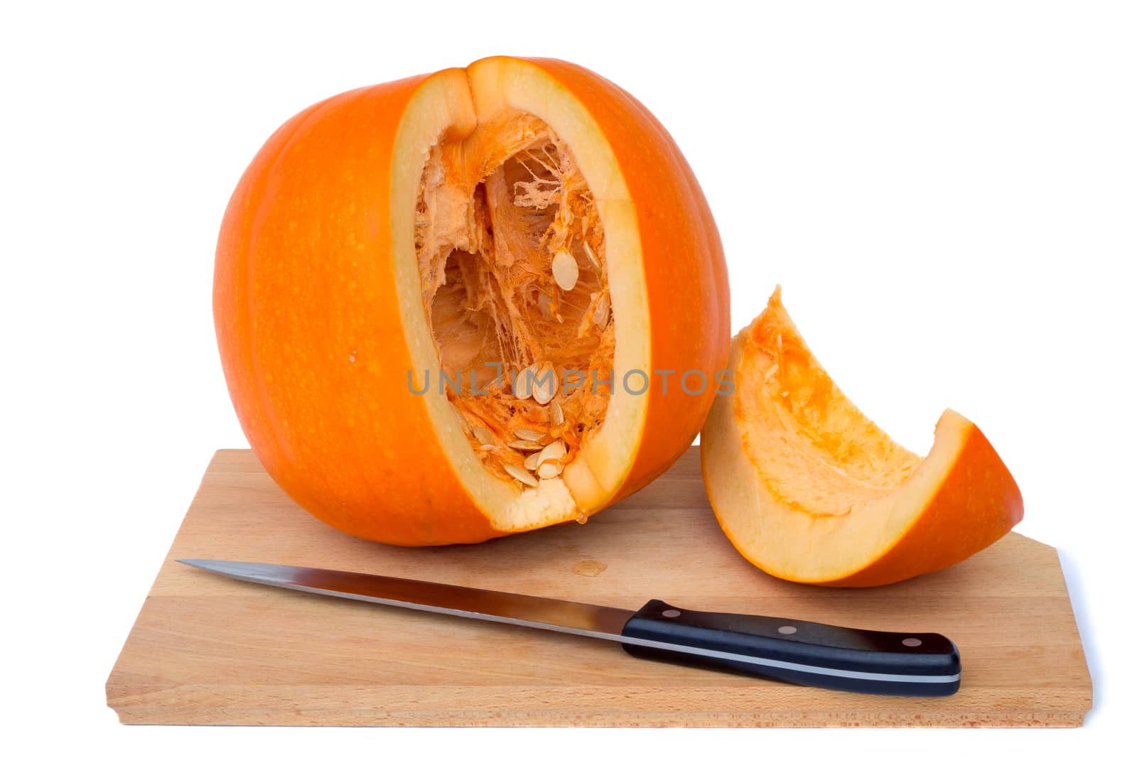 Ripe pumpkin on a cutting Board, cut along, see the middle of the pumpkin and sunflower seeds. Presented on a white background.