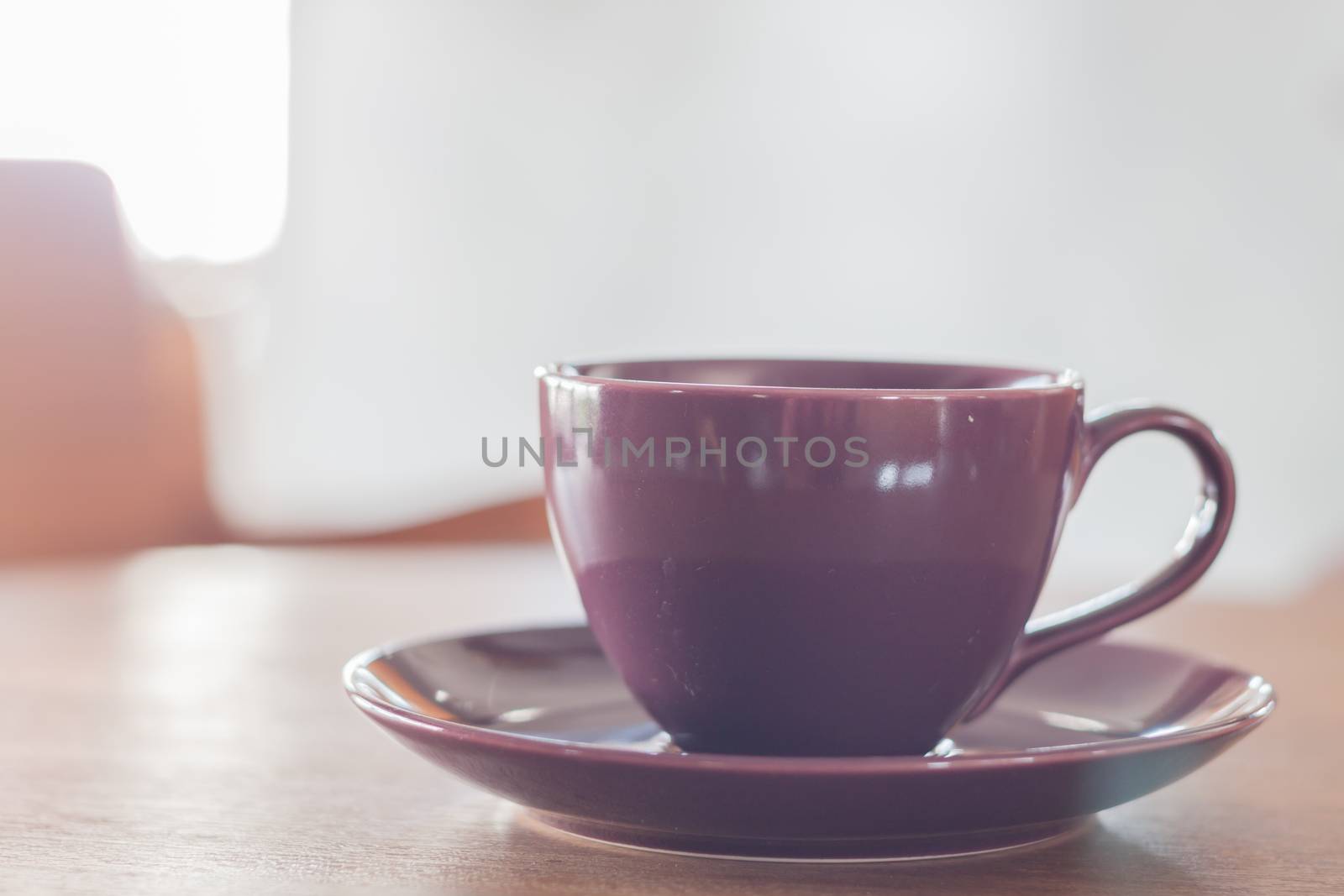 Violet coffee cup in coffee shop, stock photo