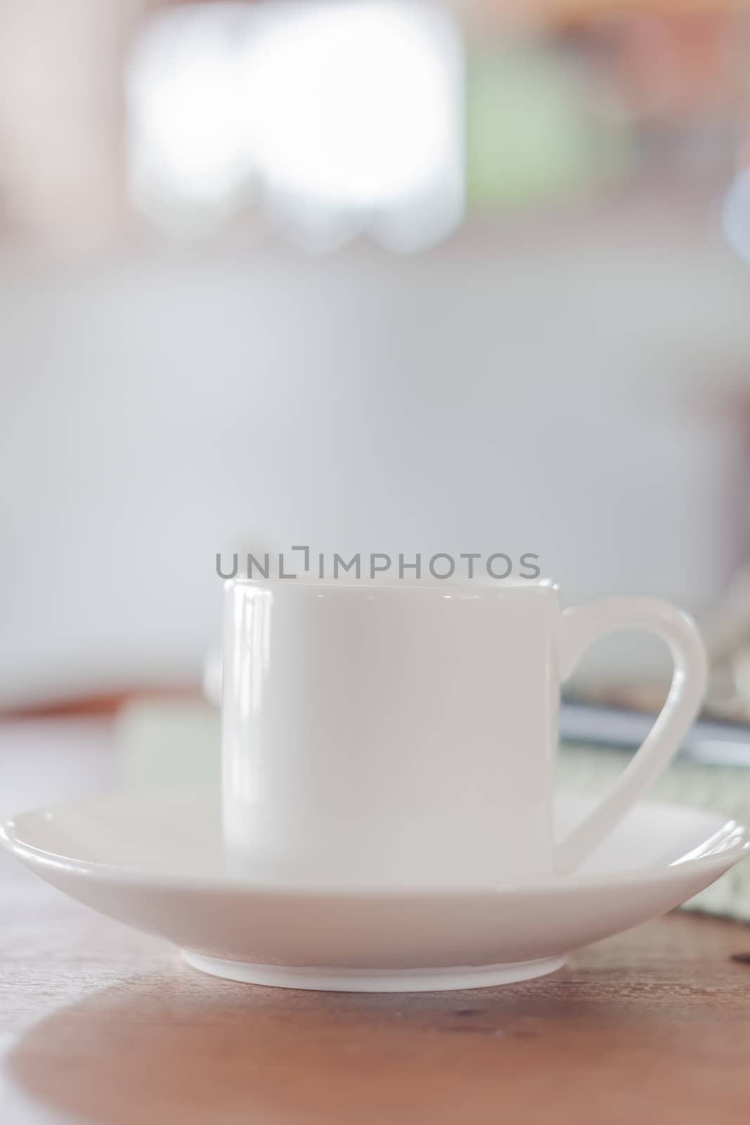 Mini white coffee cup in coffee shop, stock photo