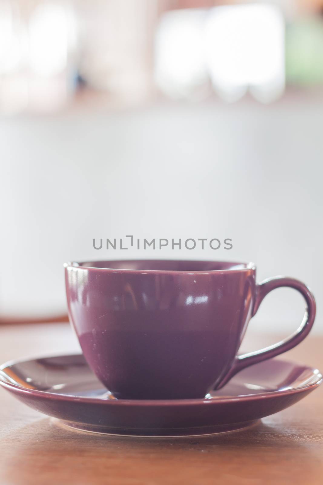 Violet mug on wooden table by punsayaporn