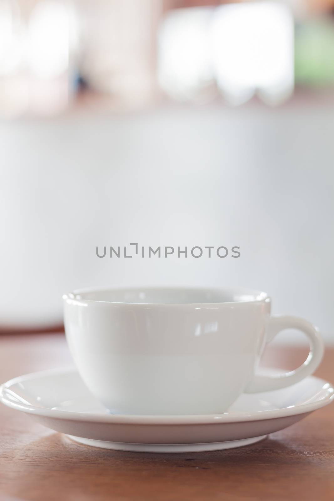 White mug on wooden table by punsayaporn