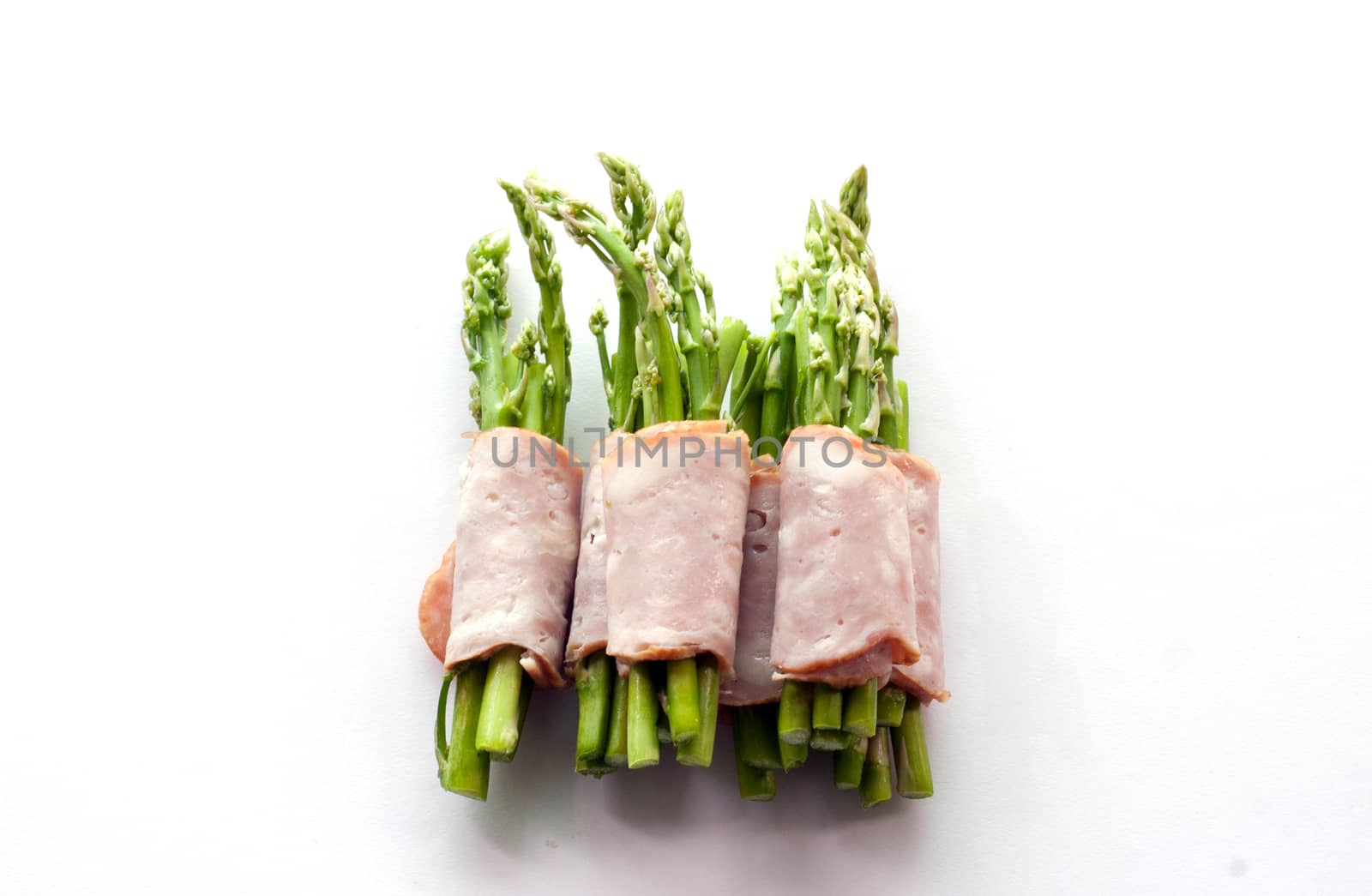 close up bacon wrapping asparagus on isolate