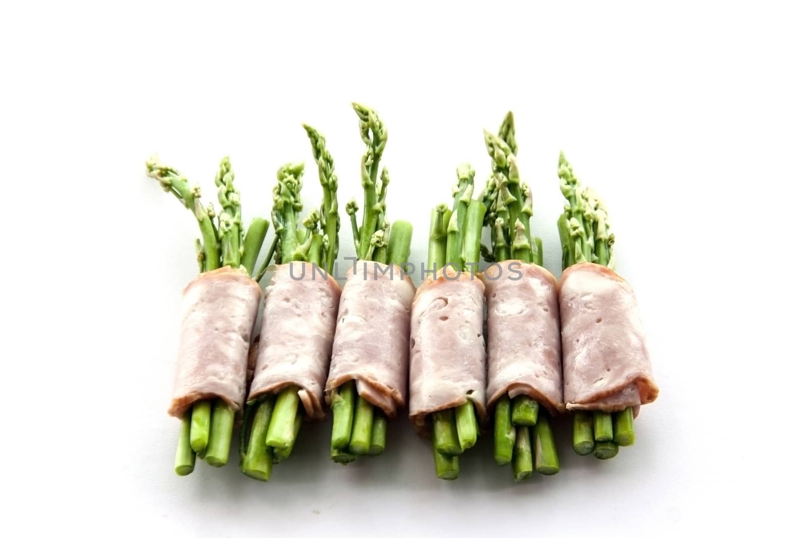 bacon wrapping asparagus on isolate by yanukit