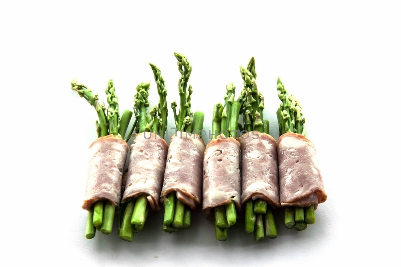 bacon wrapping asparagus on isolate by yanukit