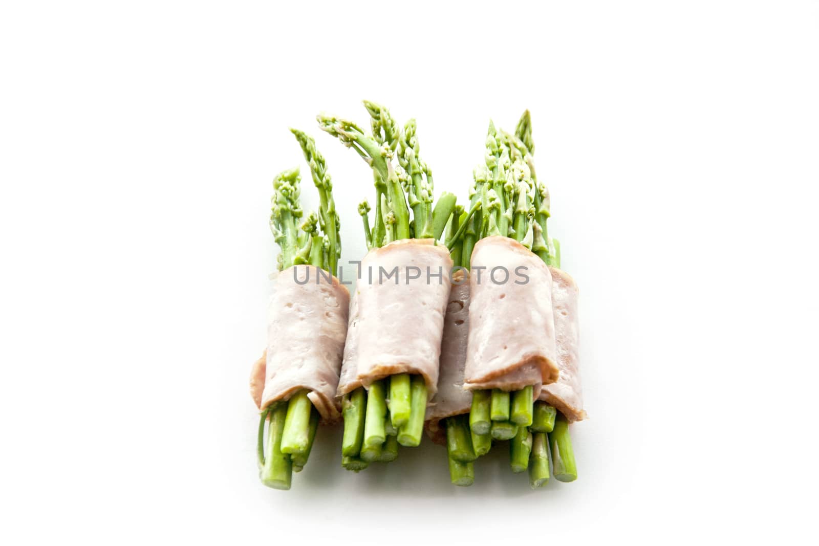 close up bacon wrapping asparagus on isolate