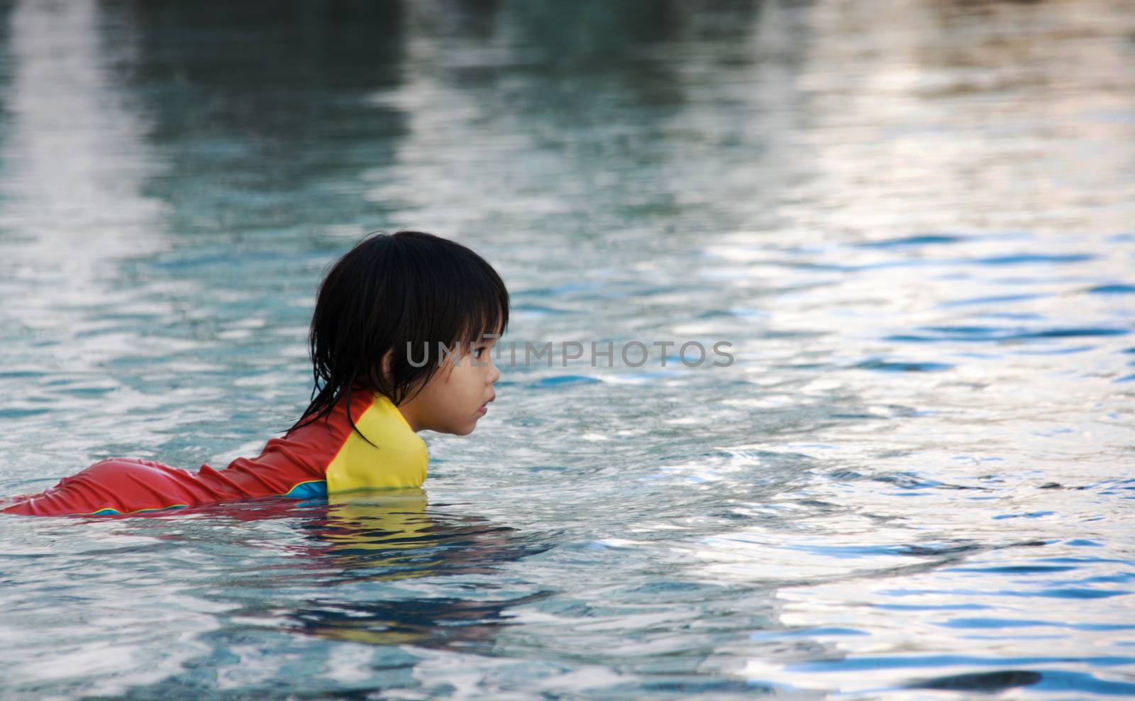 children play onwater in swimimg pool by yanukit