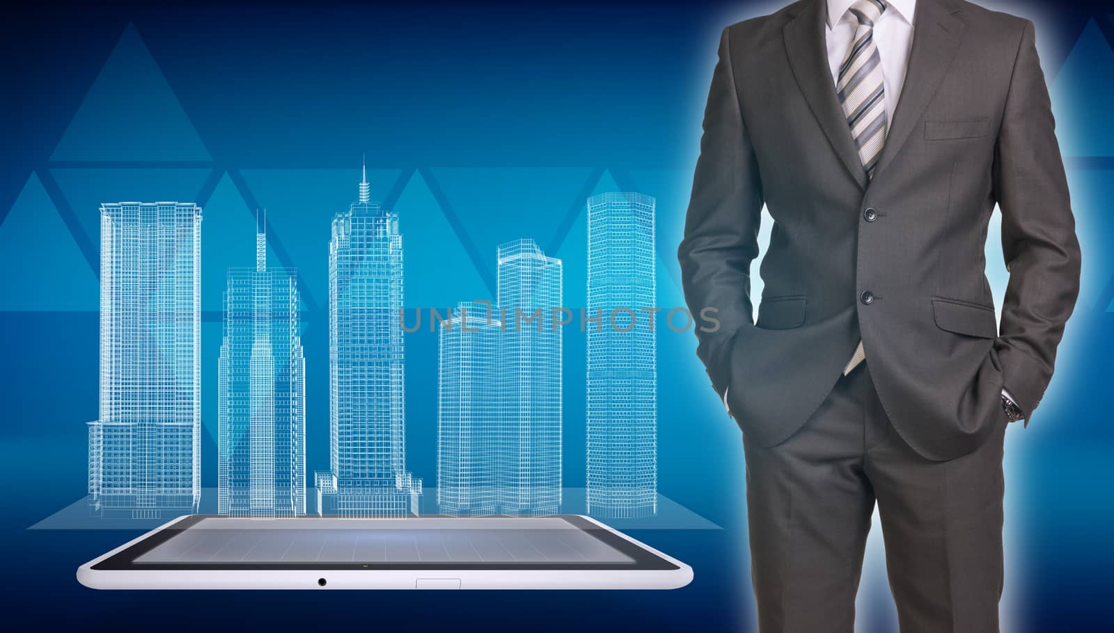 Businessman in suit standing and holds hands in pockets. Glowing wire-frame buildings on screen tablet pc as backdrop