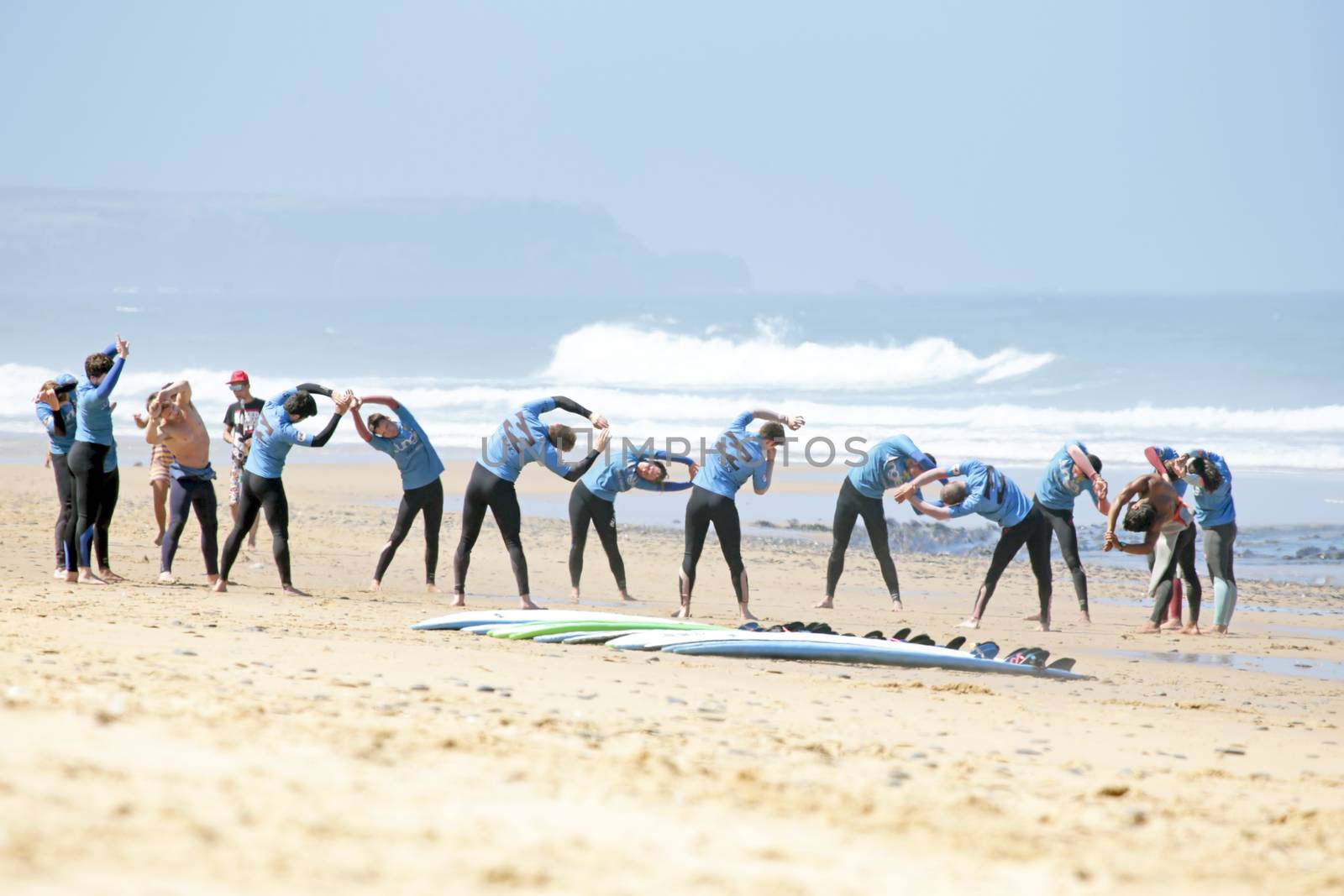 VALE FIGUEIRAS, PORTUGAL - August 16 2014:  Surfers doing excersises on the famous surfers beach Vale Figueiras in Portugal