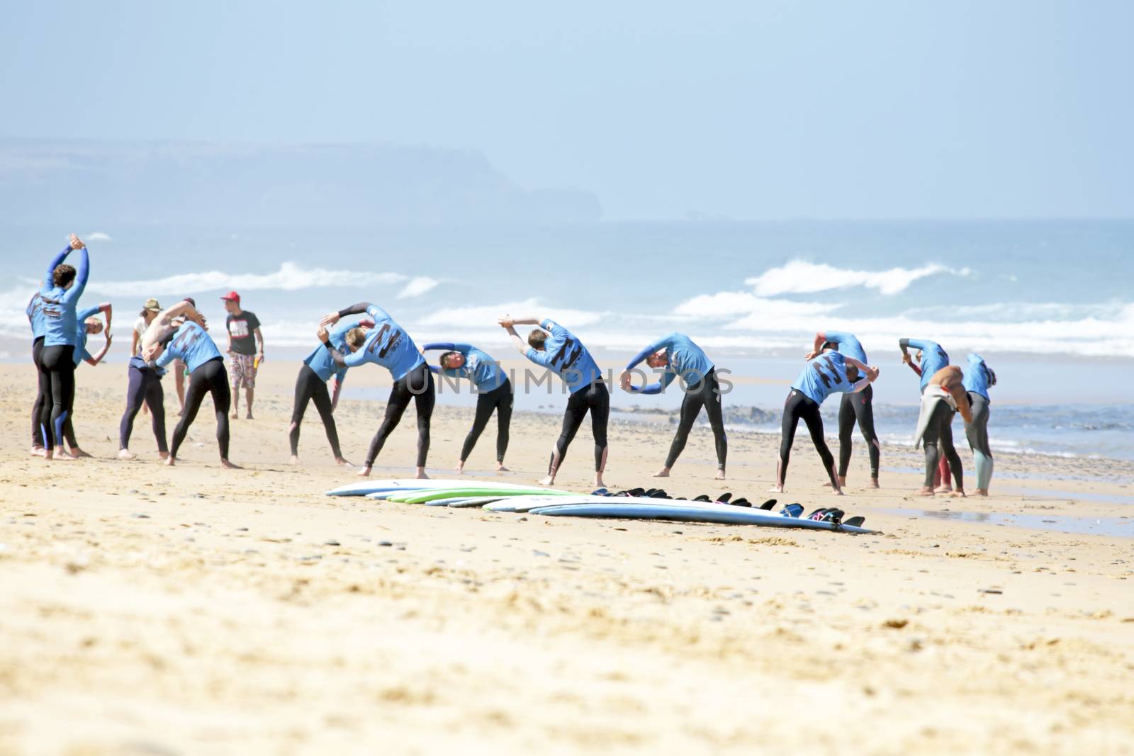VALE FIGUEIRAS, PORTUGAL - August 16 2014:  Surfers doing excersises on the famous surfers beach Vale Figueiras in Portugal