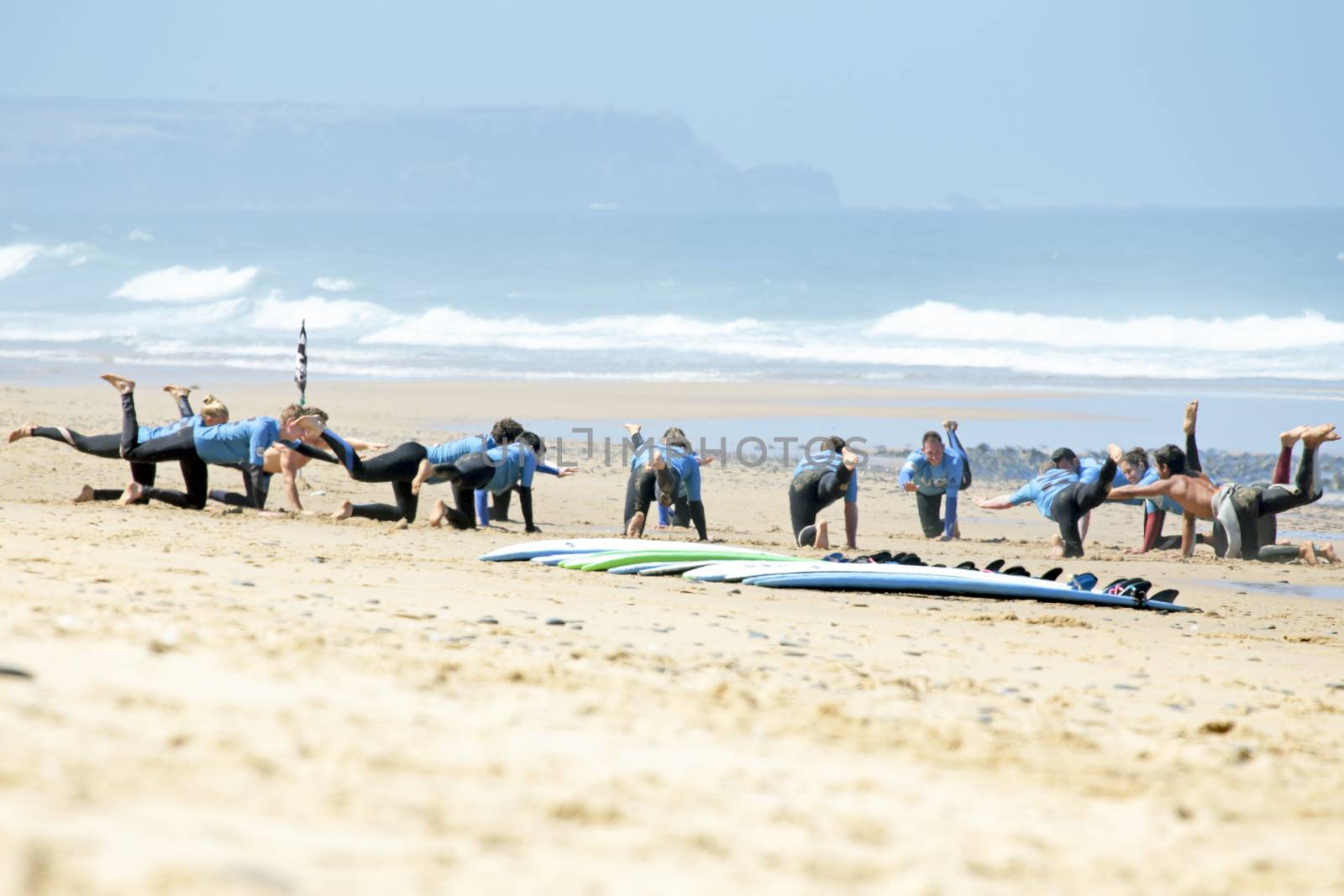 VALE FIGUEIRAS, PORTUGAL - August 16 2014:  Surfers doing excersises on the famous surfers beach Vale Figueiras in Portugal