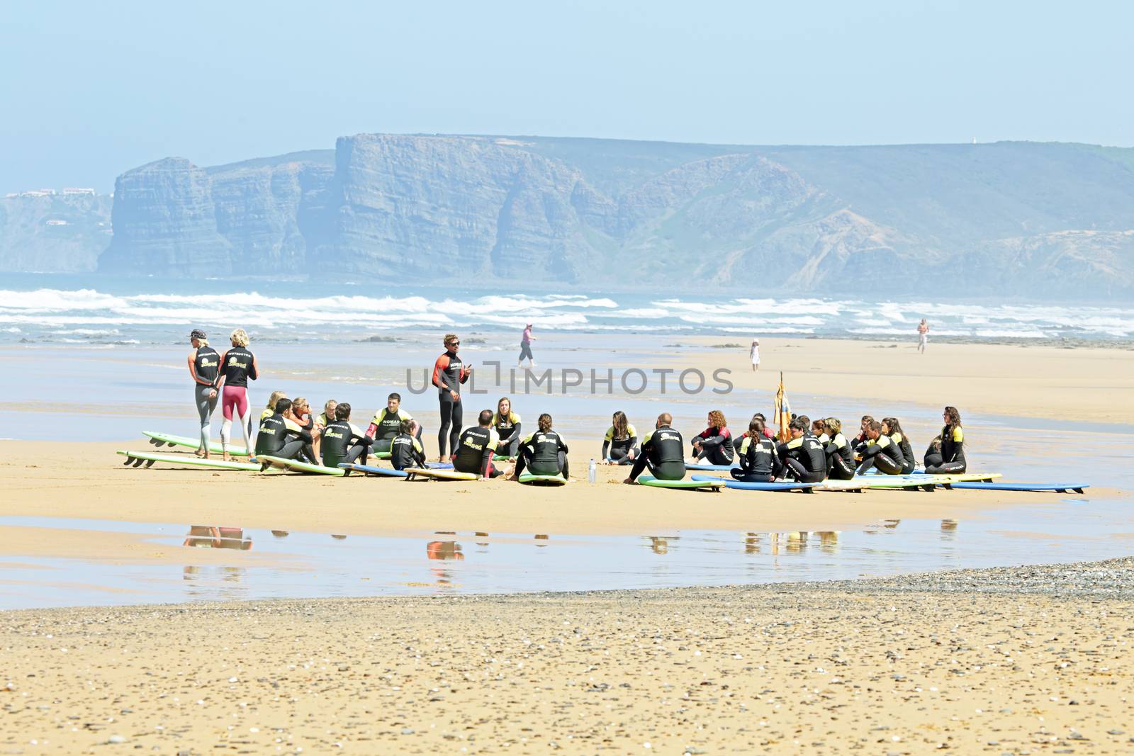 VALE FIGUEIRAS, PORTUGAL - August 16 2014:  Surfers doing excersises on the famous surfers beach Vale Figueiras in Portugal