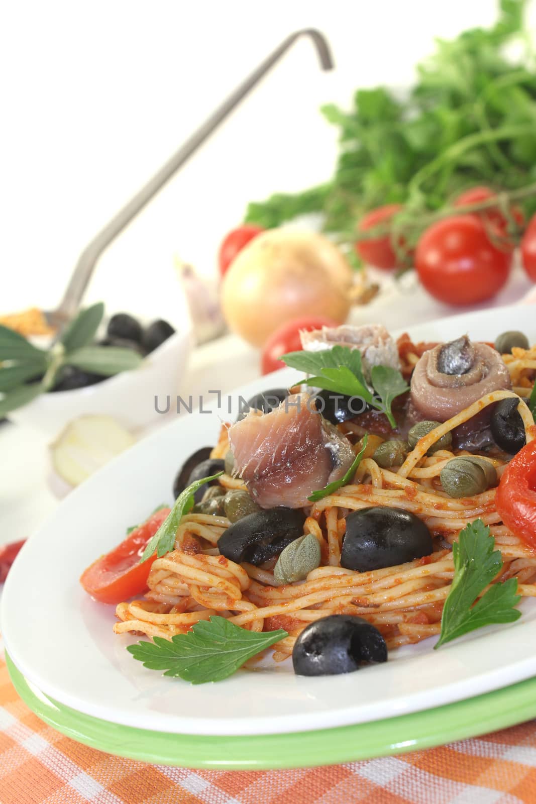 Spaghetti alla puttanesca with olives and anchovies by discovery