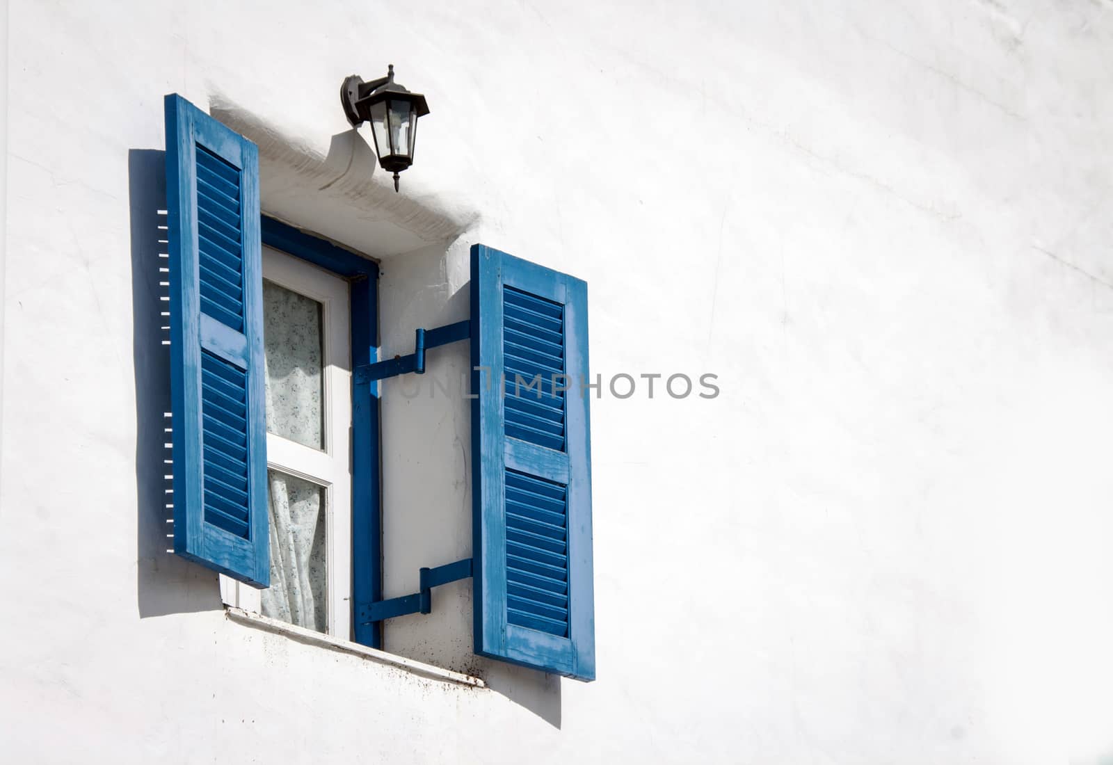 blue vintage windows on white cement wall background
