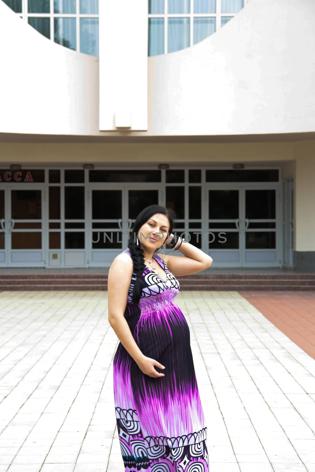 The pregnant girl on walk in city park