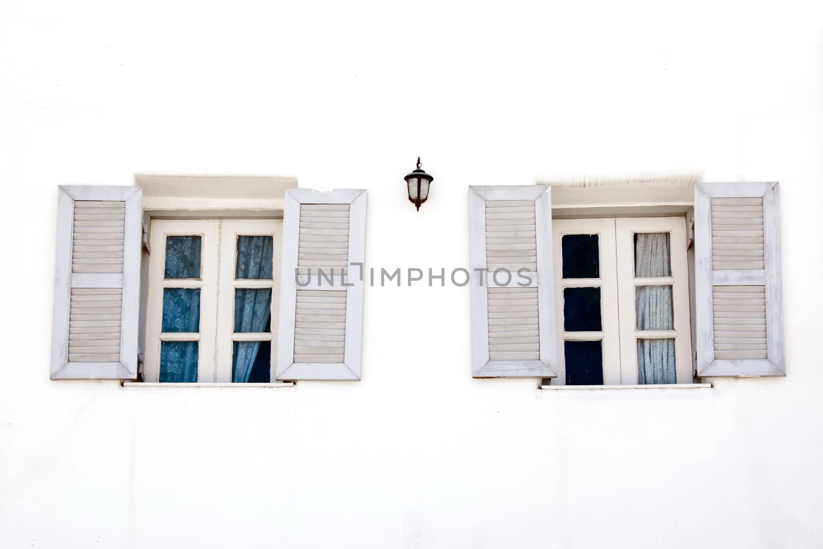 vintage windows on white cement wall by yanukit