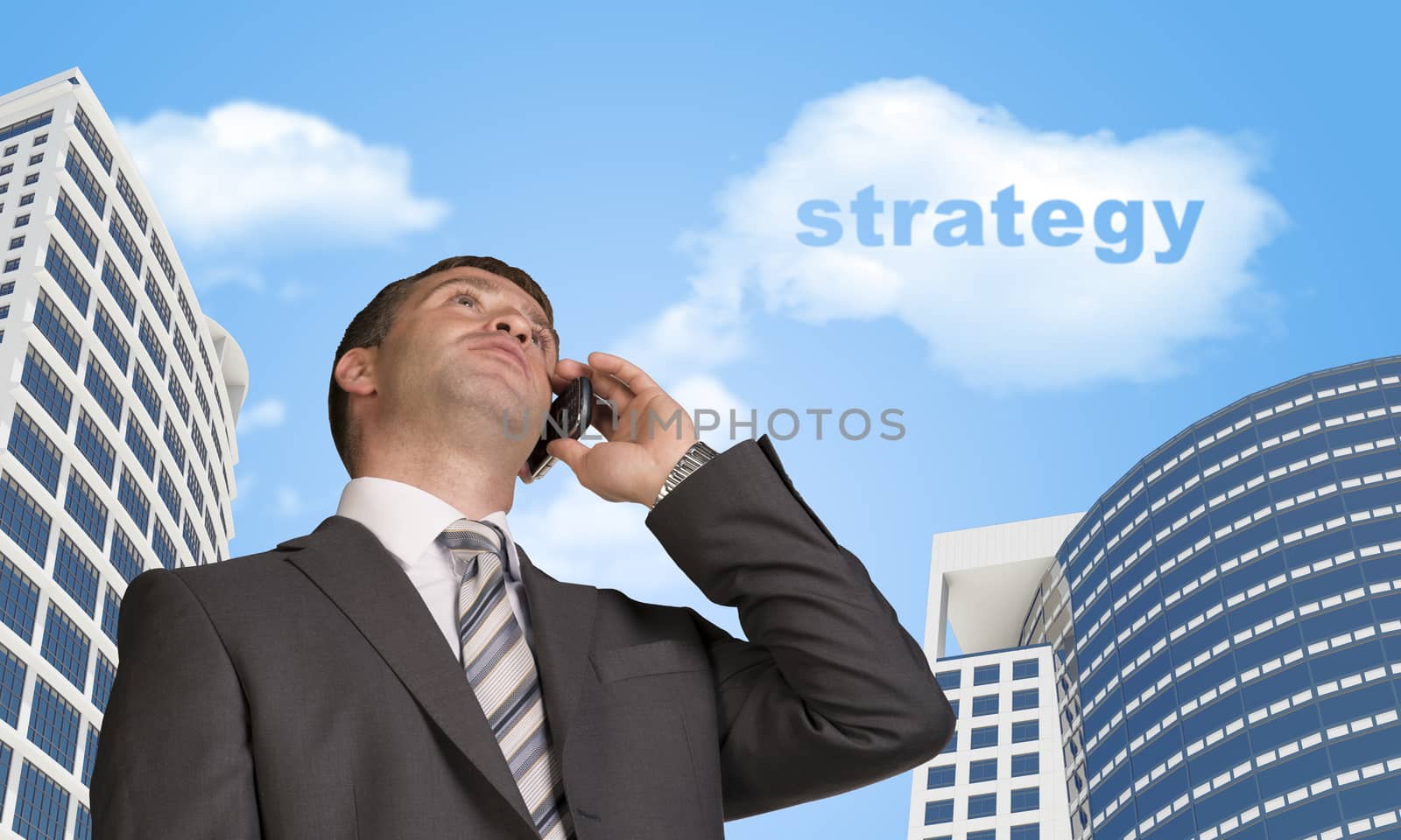 Businessman talking on the phone. Skyscrapers and cloud with word strategy in background