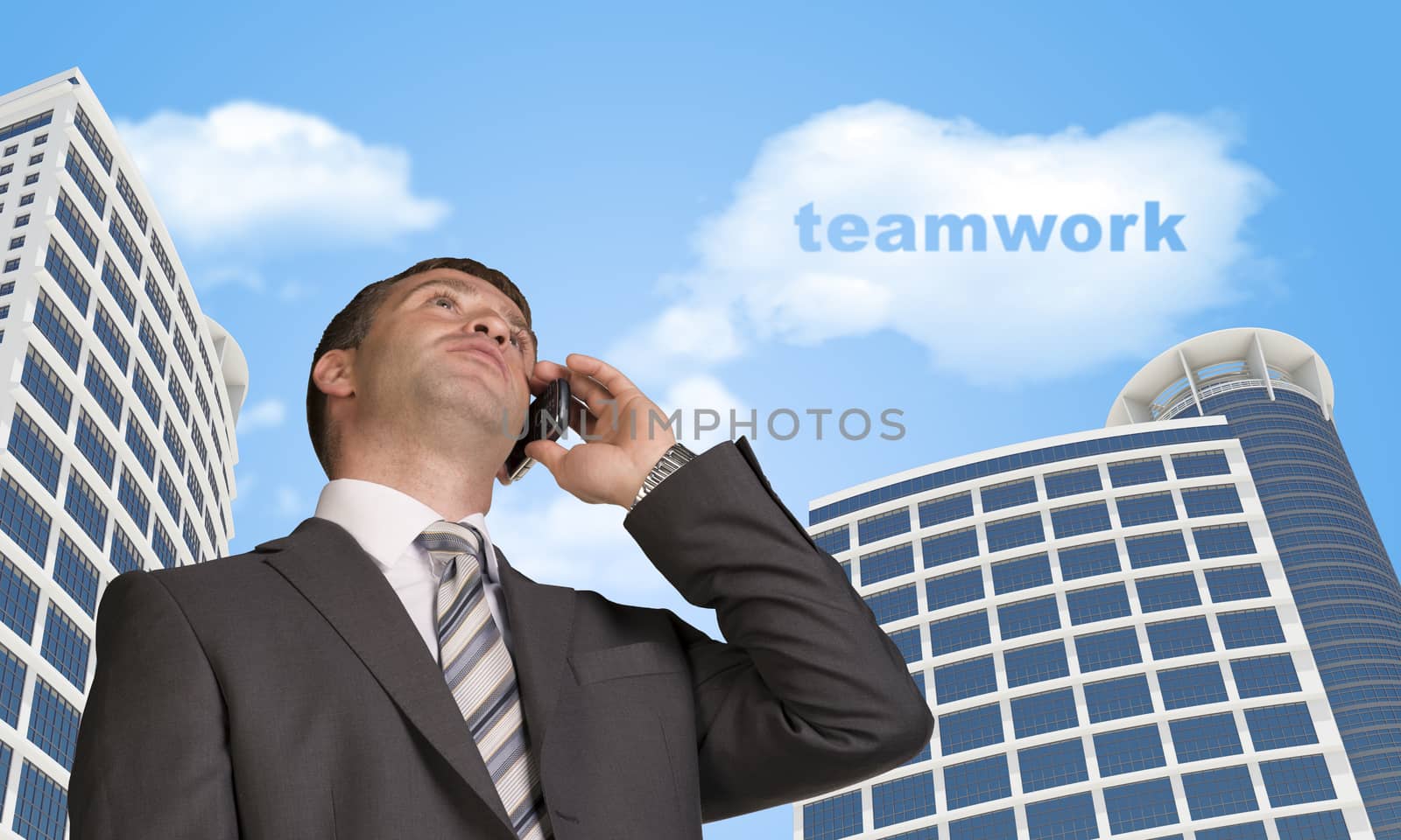 Businessman talking on the phone. Skyscrapers and cloud with word teamwork in background