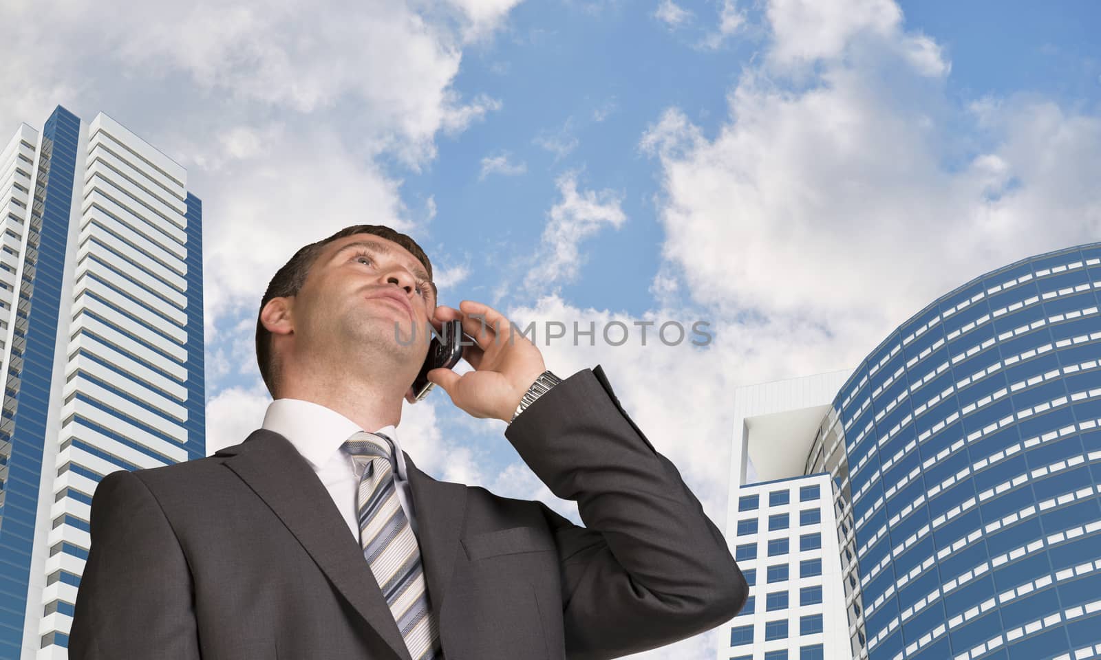 Businessman talking on the phone. Skyscrapers and clouds by cherezoff