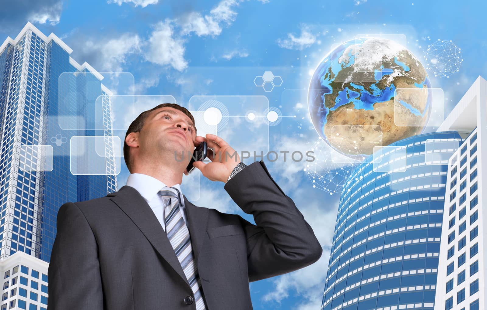 Businessman talking on the phone. Skyscrapers and Earth with transparent rectangles. Element of this image furnished by NASA