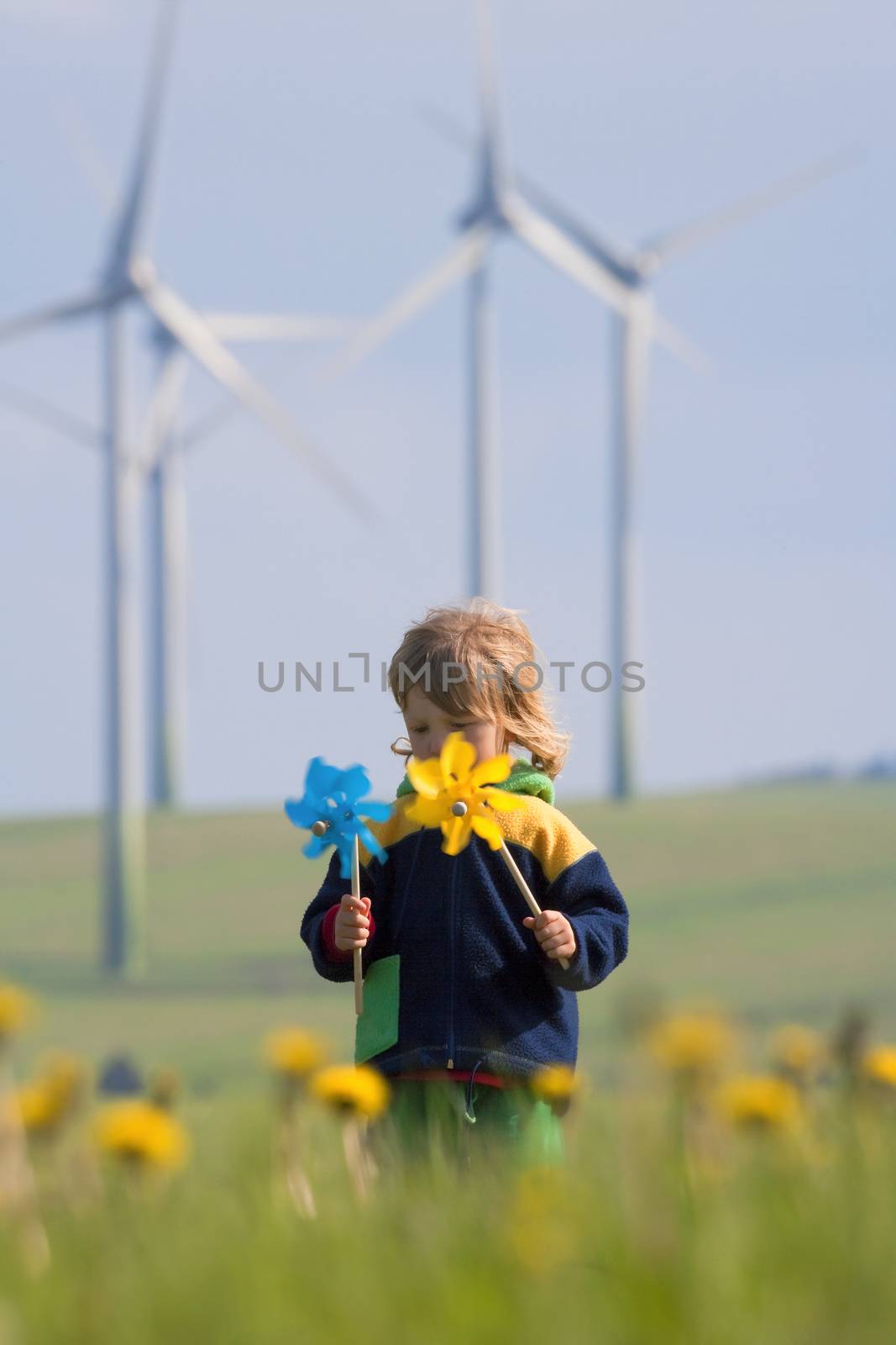 boy with pinwheel and wind farm by courtyardpix