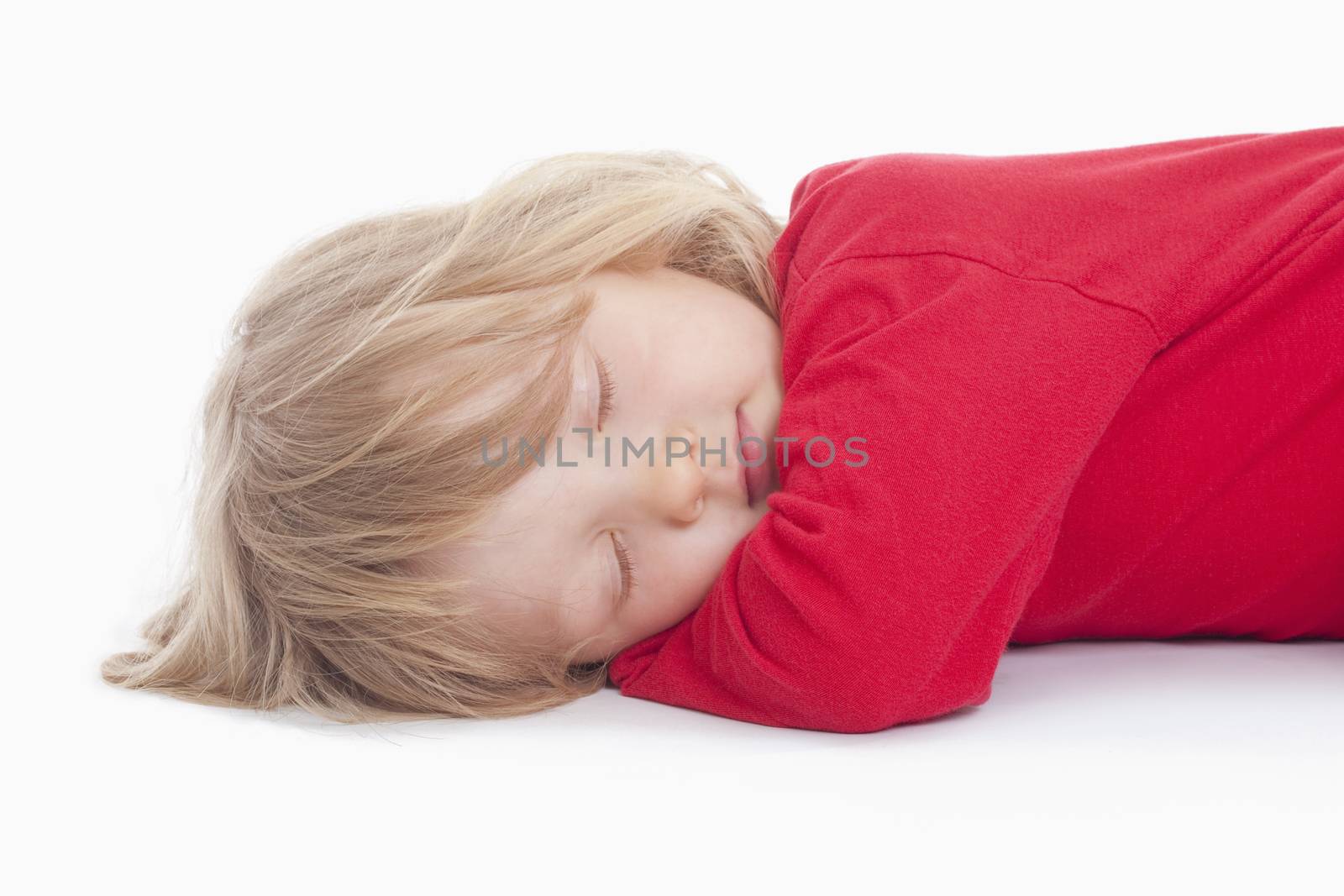 boy with long blond hair lying down sleeping - isolated on white