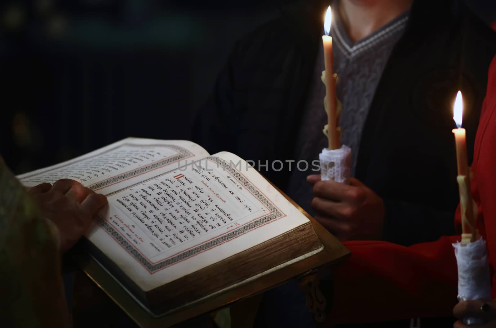 Reading the Bible in a church with candles