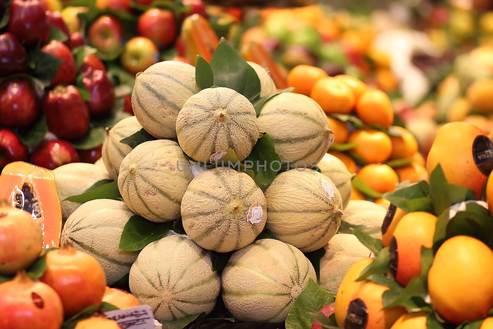 Ripe fresh melons pile in a market, exotic fruit